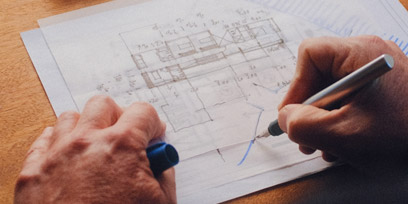 Person drawing architectural plans